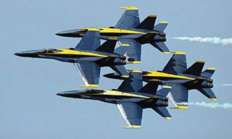 Photo of the Blue Angels jets in the air during an air show.