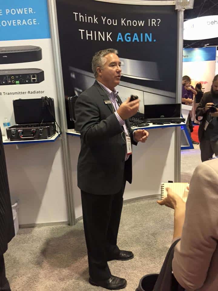 Russ Gentner at InfoComm Show talking about ListenIR receiver