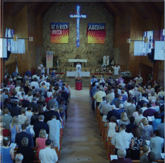 Inside of St. John's Lutheran church sanctuary filled with worshippers